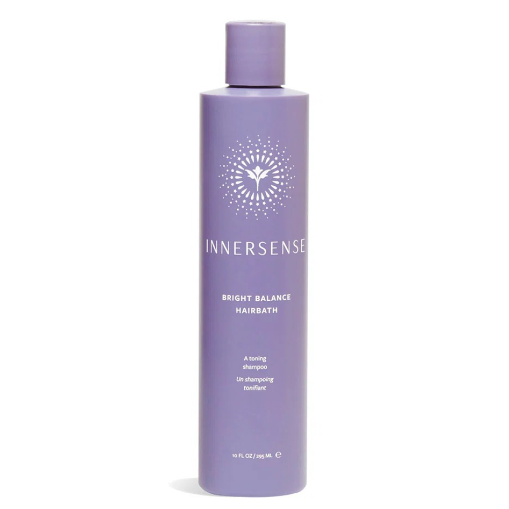 Innersense Bright Balance Hairbath, a 10 fl oz purple shampoo bottle with white text and a sunburst logo.