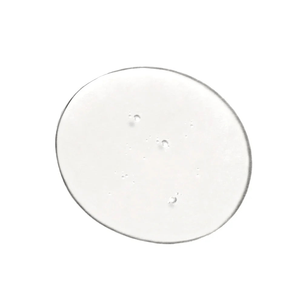 A clear, circular dollop of Innersense I Create Volume styling lotion with small air bubbles.