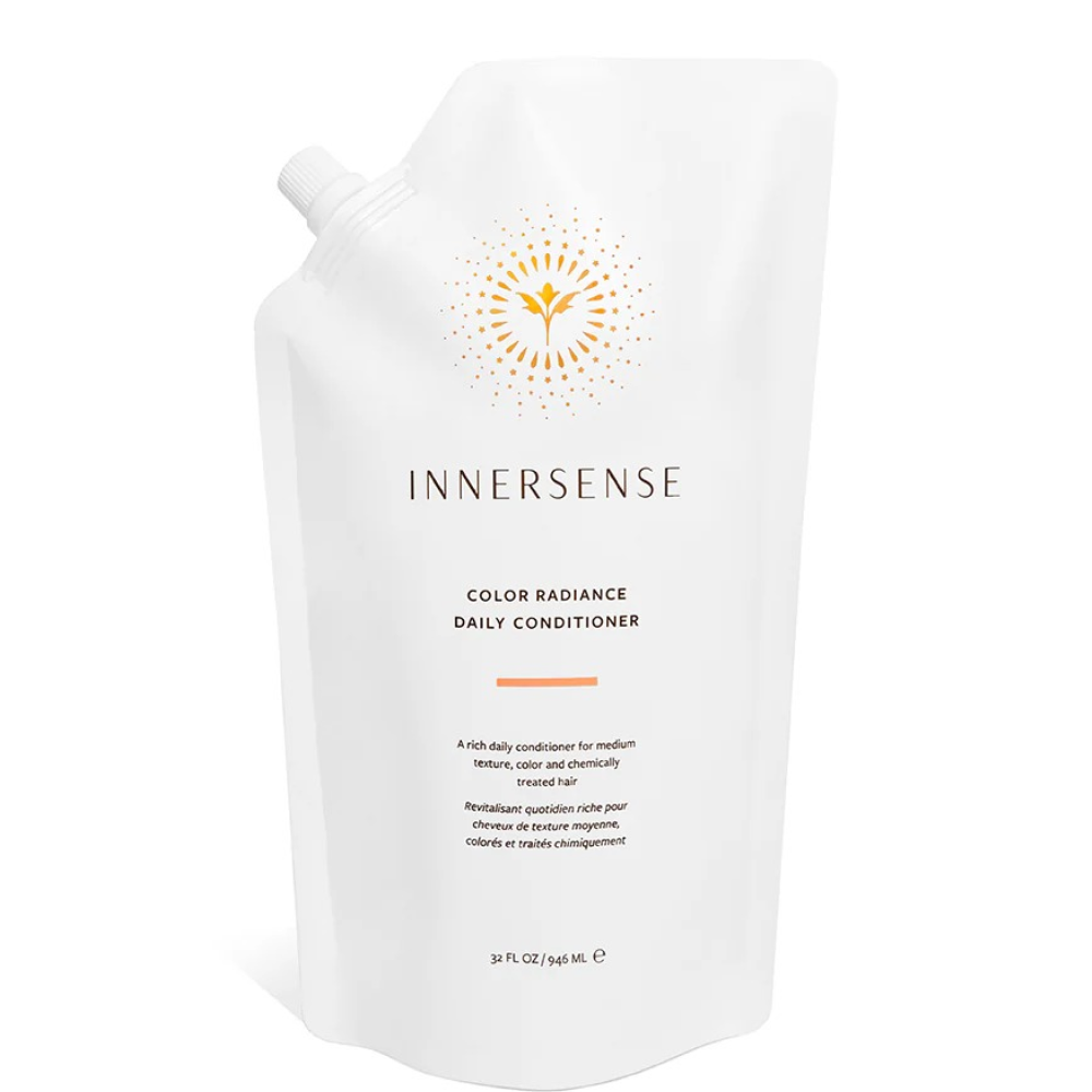White Innersense Color Radiance Daily Conditioner pouch with orange sunburst logo and text.
