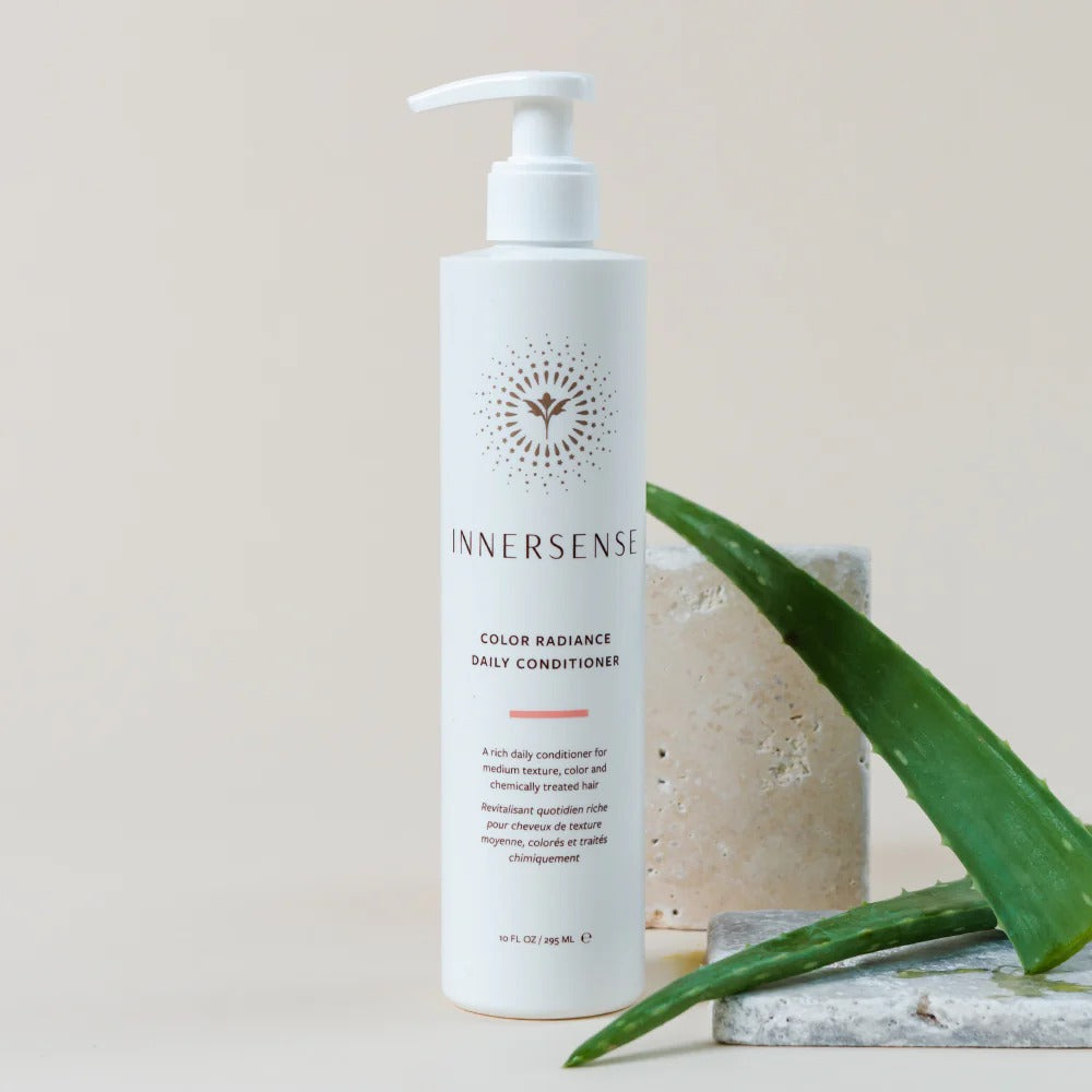 White Innersense Color Radiance Daily Conditioner pump bottle with aloe vera and stone accents.