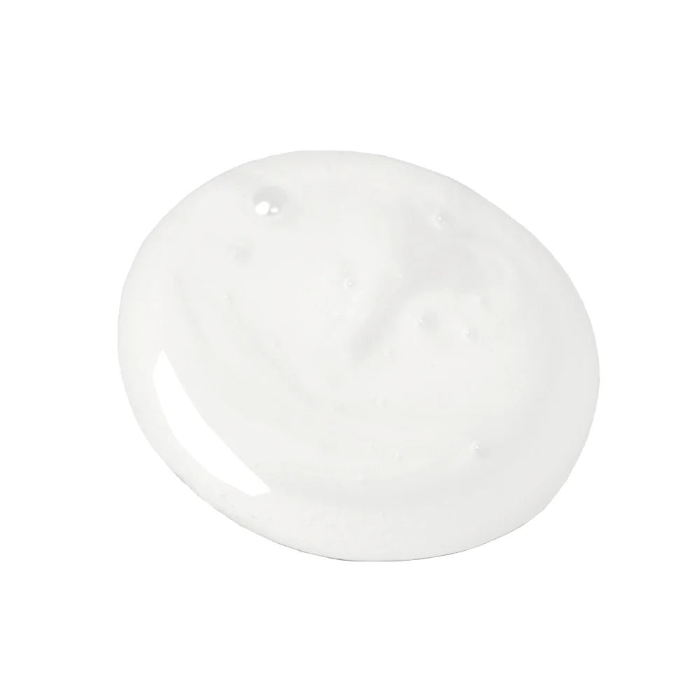 A dollop of thick, creamy white Innersense Hydrating Cream Hairbath shampoo.