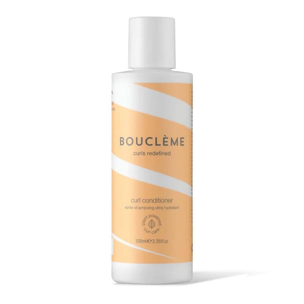 White Bouclème Curl Conditioner bottle with orange wavy stripes and a white cap.