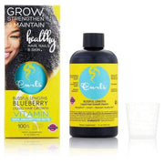 Yellow box and dark blue bottle of Curls Blueberry Blissful Lengths Liquid Hair Growth Vitamin with a measuring cup.