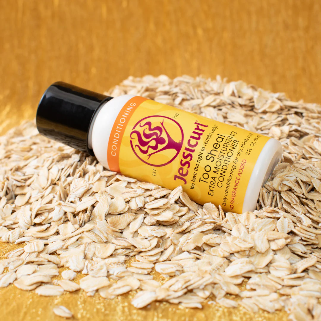 Jessicurl Too Shea! Extra Moisturizing Conditioner, a white bottle with a yellow label, on oats.