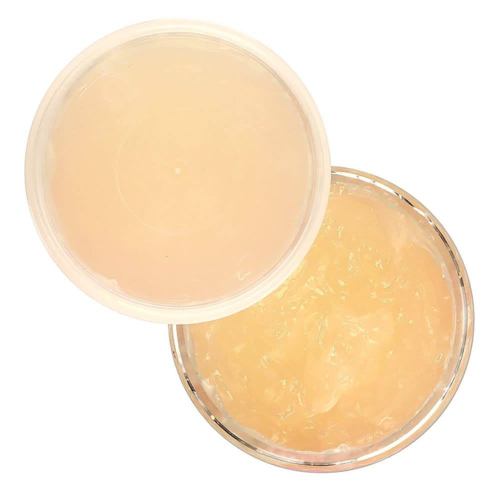 Open jar of Kinky Curly Gel Curling Custard, showing the translucent amber gel and clear lid.