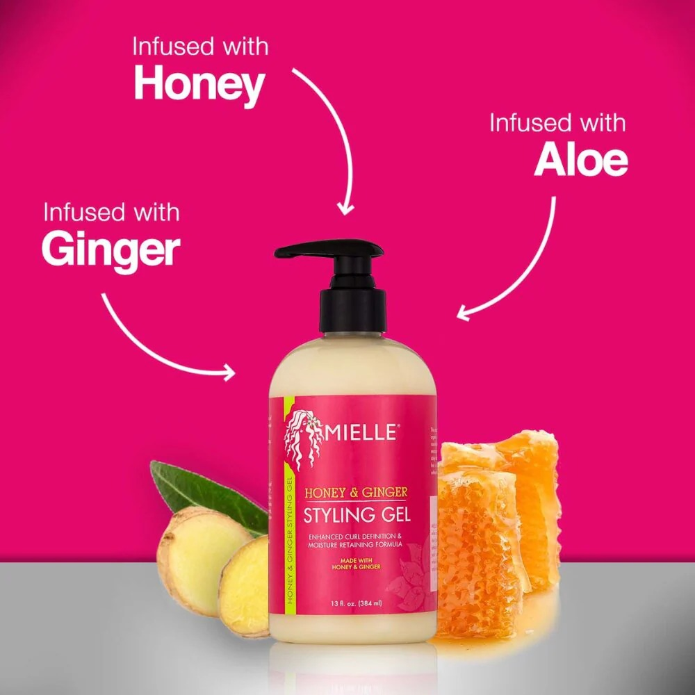 Mielle Honey & Ginger Styling Gel 384ml bottle with pump, ginger slices, and honeycomb on a pink background.