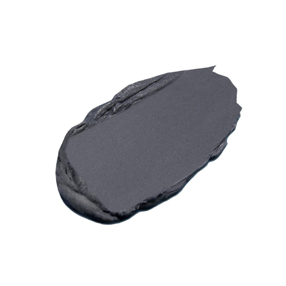 A thick, dark gray swatch of Innersense Detox Hair Mask with a creamy texture.