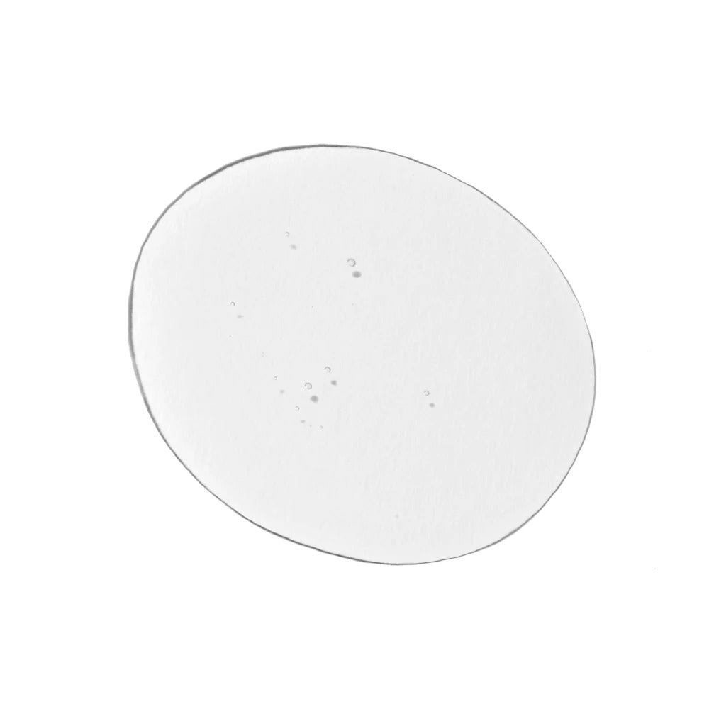 Clear, oval-shaped drop of Innersense Harmonic Treatment Oil with small bubbles.