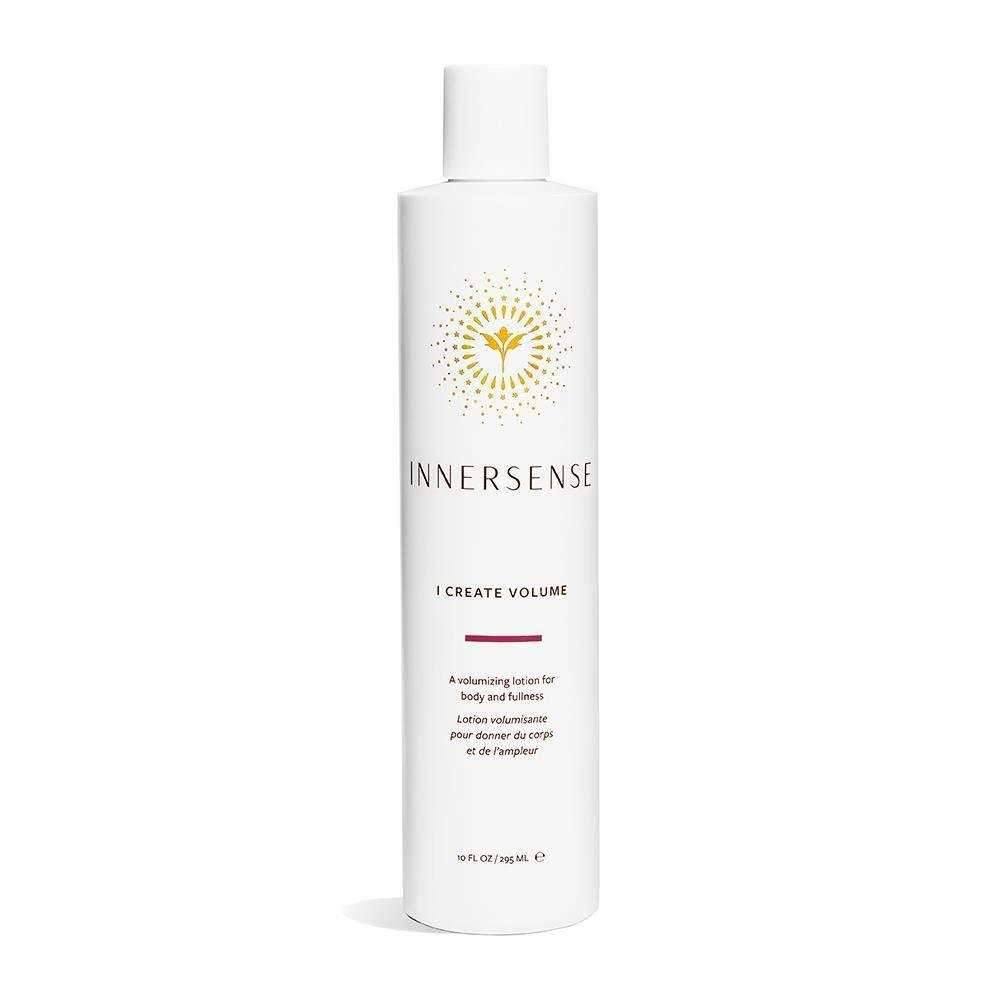 White Innersense I Create Volume styling lotion bottle with gold sunburst logo.